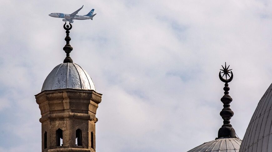 February 9, 2023, an EgyptAir aircraft flies on its landing approach past the 19th century Mosque of Mohamed Ali in the Cairo Citadel. (Photo by Amir MAKAR / AFP) (Photo by AMIR MAKAR/AFP via Getty Images)