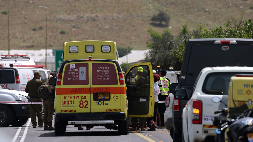 Israeli forces and emergency personnel gather near the Hamra junction, in the northern part of the Jordan valley in the occupied West Bank, following a shooting attack on April 7, 2023. - Two women were killed and another seriously wounded today in the shooting attack on a vehicle in the occupied West Bank, the Israeli army and medics said. (Photo by Jaafar ASHTIYEH / AFP) (Photo by JAAFAR ASHTIYEH/afp/AFP via Getty Images)