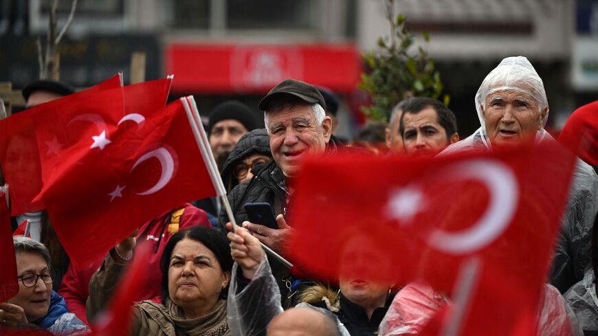 Supporters wave Turkish national flags as they attend a rally of Turkey's Republican People's Party (CHP) Chairman and Presidential candidate Kemal Kilicdaroglu in Canakkale, western Turkey, on April 11, 2023. 