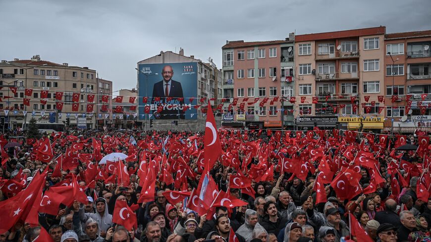 Supporters wave Turkish national flags as they attend a rally of Turkey's Republican People's Party (CHP) Chairman and Presidential candidate Kemal Kilicdaroglu in Canakkale, western Turkey, on April 11, 2023. - A sea of umbrellas and hoods at his feet, Kemal Kilicdaroglu, the Turkish opposition candidate who will challenge Recep Tayyip Erdogan at the polls on 14 May, smilingly promises "the return of spring". (Photo by OZAN KOSE / AFP) (Photo by OZAN KOSE/AFP via Getty Images)