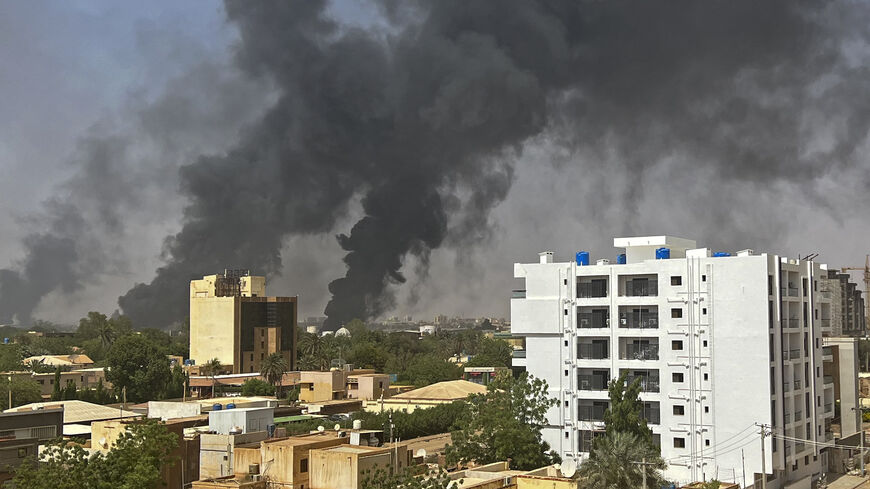 Smoke billows above residential buildings in Khartoum on April 16, 2023.
