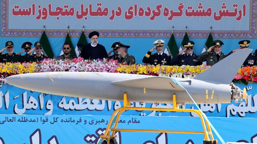 Iran's President Ebrahim Raisi watches combat drones alongside high-ranking officials and commanders during a military parade marking the country's annual army day in Tehran on April 18, 2023. 