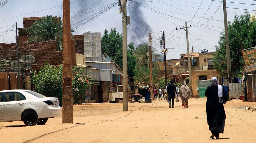 Smoke rises behind buildings in Khartoum on April 19, 2023, as fighting between the army and paramilitaries raged for a fifth day after a 24-hour truce collapsed.