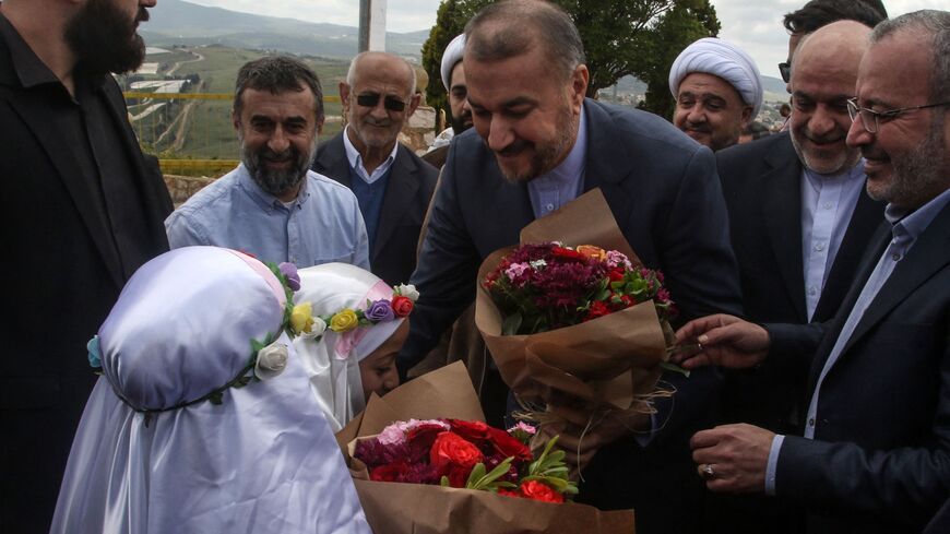 Children offer flowers to Iranian Foreign Minister Hossein Amir-Abdollahianin during his visit to the southern Lebanese village of Maroun al-Ras near the border with Israel, on April 28, 2023. - Abdollahian called on Lebanon on April 27 to overcome political deadlock and elect a president, urging foreign governments not to interfere in the choice. (Photo by Mahmoud ZAYYAT / AFP) (Photo by MAHMOUD ZAYYAT/AFP via Getty Images)