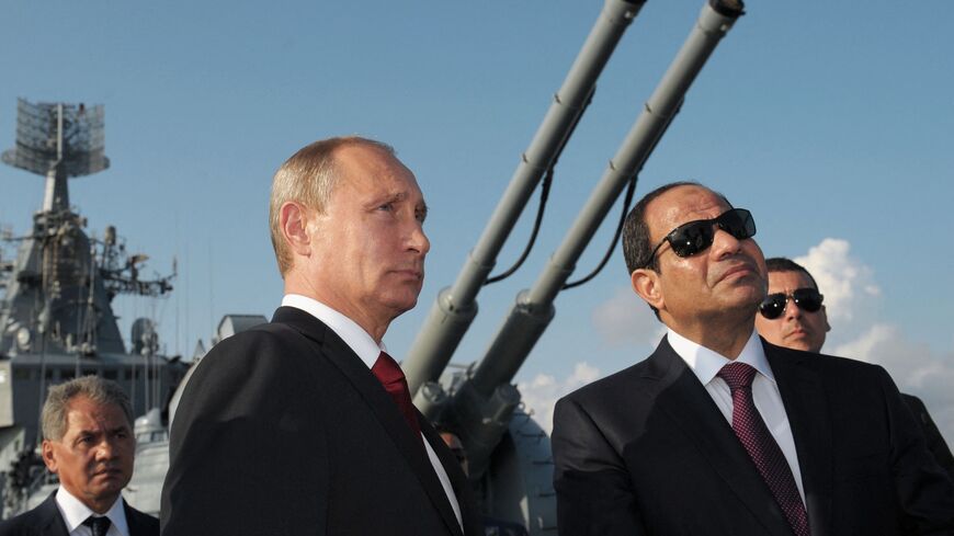 Russian President Vladimir Putin (L) and Egyptian President Abdel Fattah el-Sisi (R) listen to explanations during their visit to the Black Sea Fleet's guards missile cruiser Moskva in the sea port of Sochi on August 12, 2014 during the Egyptian leader's first official visit to Russia. AFP PHOTO / RIA NOVOSTI / KREMLIN POOL / ALEXEI DRUZHININ (Photo by ALEXEI DRUZHININ / RIA NOVOSTI / AFP) (Photo by ALEXEI DRUZHININ/RIA NOVOSTI/AFP via Getty Images)