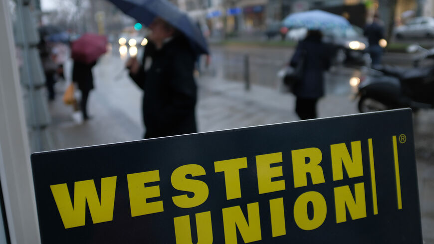 A sign advertises the money transfer service Western Union on January 11, 2018 in Berlin, Germany. Much of the German financial services, consumer goods and foodstuffs economy is dominated by nationwide chains and brands. (Photo by Sean Gallup/Getty Images)
