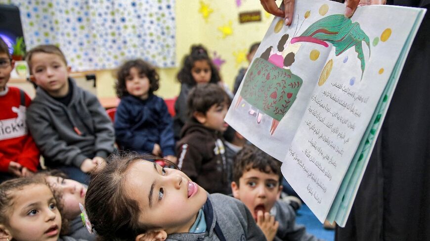 Jordanian teacher Huda Abu al-Khair reads stories to children in a classroom in Amman as part of the "We Love Reading" initiative