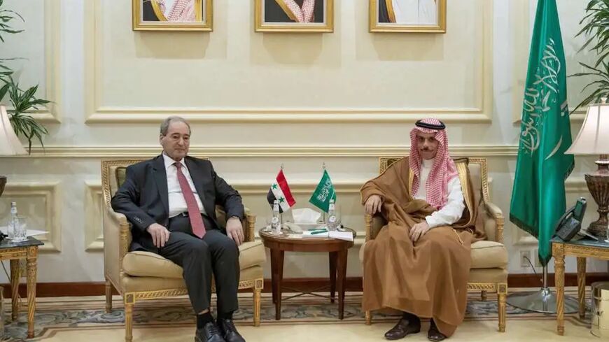 Syrian Foreign Minister Faisal Mekdad (left) meets with Saudi Foreign Affairs Minister Prince Faisal bin Farhan in Jeddah on April 12, 2023.