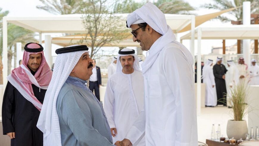 King of Bahrain Hamad bin Isa Al Khalifa greets Emir of Qatar Sheikh Tamim bin Hamad Al Thani in Abu Dhabi, Jan. 18, 2023.