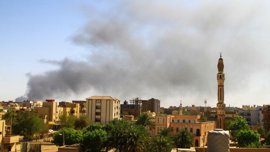 Smoke billows over Khartoum after one month of fighting between two rival Sudanese generals, on May 15, 2023