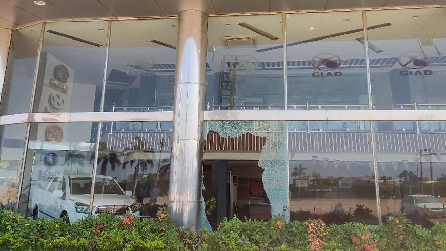 Broken glass of a car showroom in southern Khartoum after a looting attempt while fighting continues in the Sudanese capital