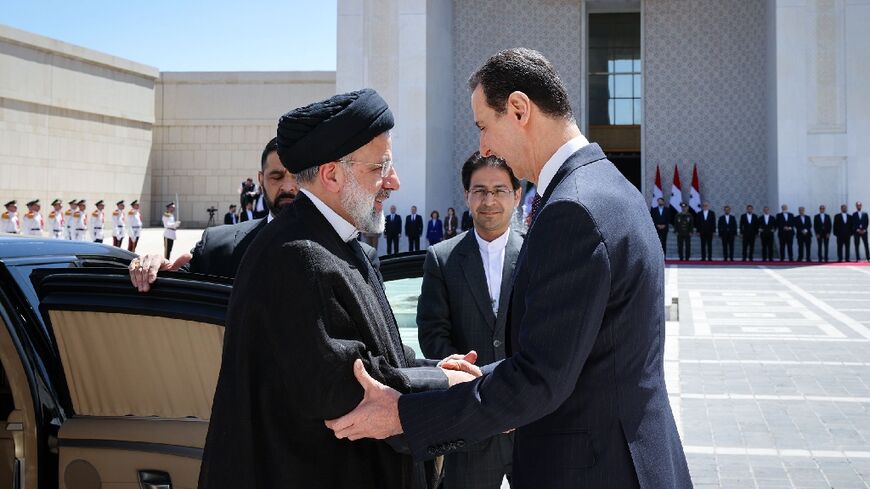 Syria's President Bashar al-Assad, on the right, received his Iranian counterpart Ebrahim Raisi at the presidential palace in Damascus on May 3, 2023
