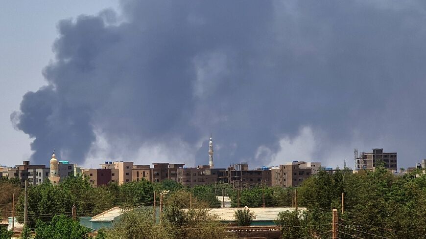 Smoke billows over buildings in Khartoum on May 1, 2023 as deadly clashes between rival generals' forces have entered their third week