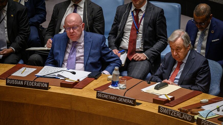Russian ambassador Vasily Nebenzya sits next to UN Secretary-General Antonio Guterres at a Security Council meeting on May 23, 2023