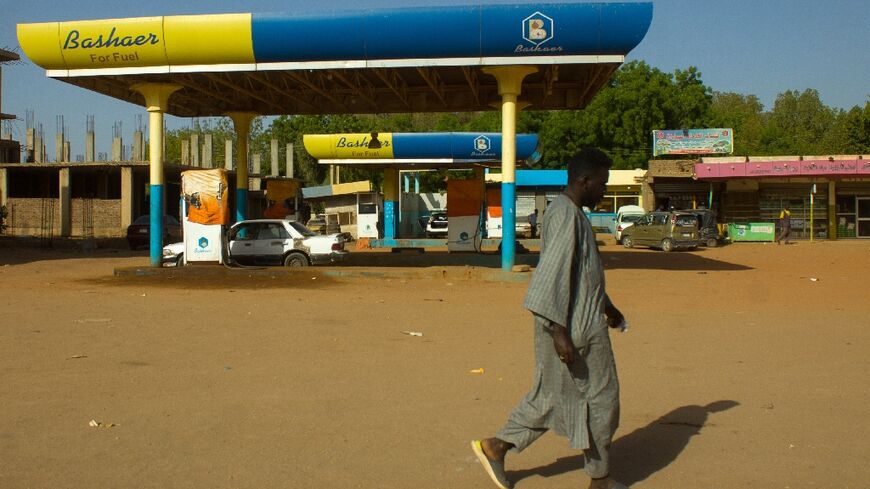 A man walks past a shuttered petrol station in Madani, southeast of the Sudanese capital Khartoum