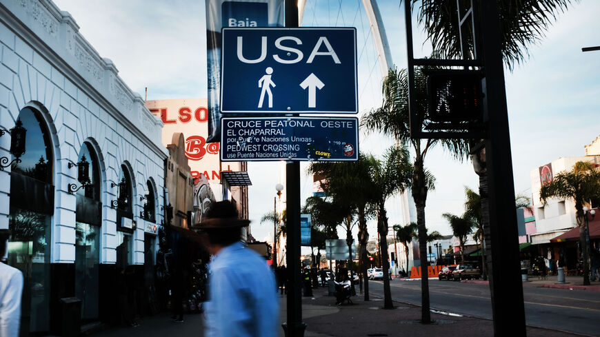 A sign directs pedestrians towards the United States on January 16, 2019 in Tijuana, Mexico. Thousands of people from Mexico and Central America, many who arrived in caravans, hope to cross the border daily into America. The U.S. government is partially shut down as President Trump is asking for $5.7 billion to build additional walls along the U.S.-Mexico border and the Democrats oppose the idea. (Photo by Spencer Platt/Getty Images)