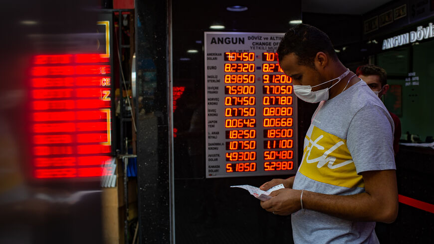 A man wearing a face mask leaves after changing money at an exchange office in Istanbul, Turkey, July 29, 2020.