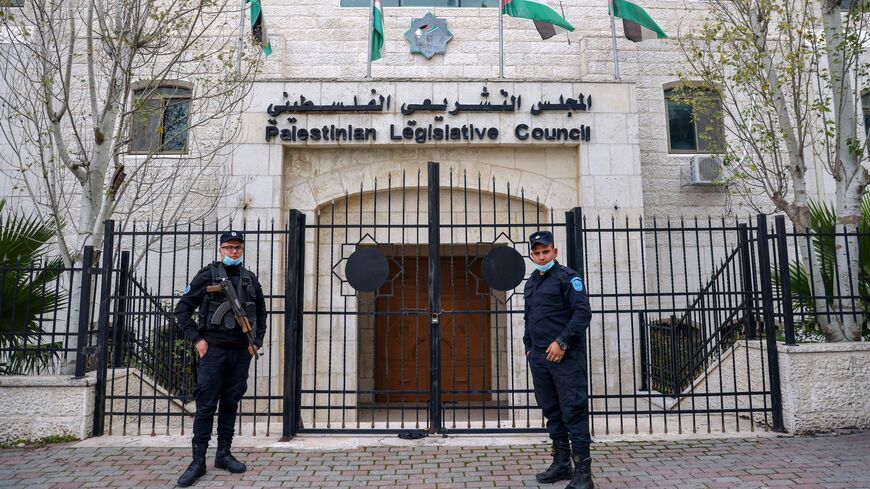 Members of the Palestinian security forces stand guard outside the Legislative Council building.
