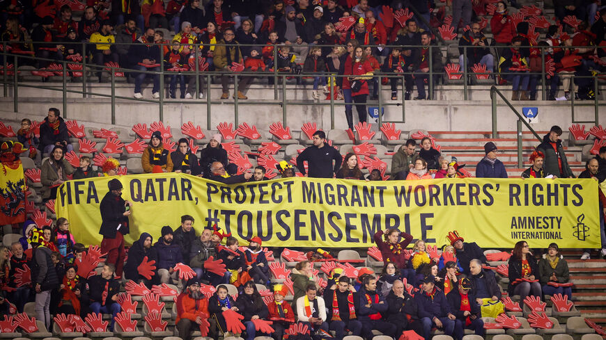 Belgium's supporters with a banner to ask for protection of migrant workers' rights in Qatar.