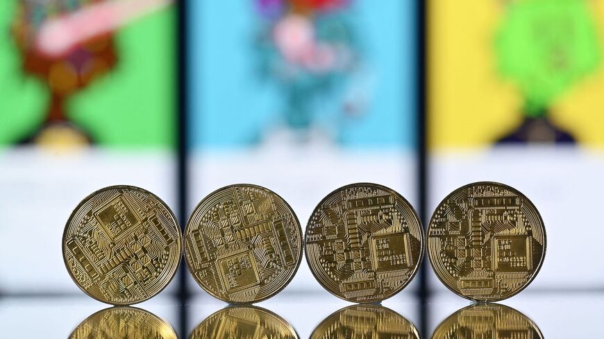 An illustration picture taken in London on Dec. 30, 2021, shows gold-plated souvenir cryptocurrency coins.