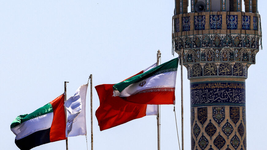 The flags of Iran (R) and of the UAE (L).