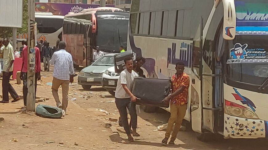 People flee the southern part of Khartoum as street battles between the army and paramilitaries continue, on April 27, 2023.