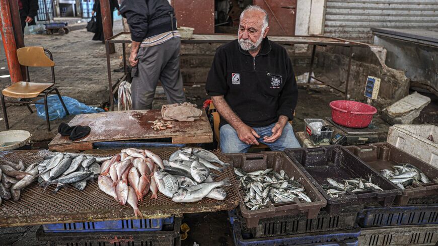 A picture taken on April 29, 2023, shows a Palestinian fish vendor at a market in Gaza City. 