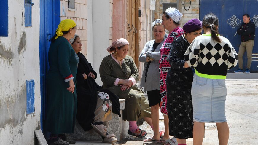 Women gather oustide a house at the Hara Kebira, the main Jewish quarter in the resort island of Djerba, after attending a ceremony at the Ghriba synagogue following a shooting spree by a police officer on the southern Tunisian island on May 10, 2023. Tunisian authorities were investigating the shootings that claimed five lives and sparked mass panic during a Jewish pilgrimage at Africa's oldest synagogue today. (Photo by FETHI BELAID / AFP) (Photo by FETHI BELAID/AFP via Getty Images)