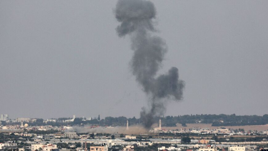 A plume of smoke rises above buildings during an Israeli strike on Khan Yunis, on May 10, 2023. Israel announced it was targeting rocket launch sites of the militant group Islamic Jihad. Gaza's health ministry said five people were killed, a day after Israeli strikes on the Palestinian territory left 15 dead. (Photo by SAID KHATIB / AFP) (Photo by SAID KHATIB/AFP via Getty Images)