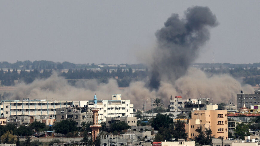 A plume of smoke rises above buildings during an Israeli strike east of Rafah, in the southern Gaza Strip, on May 11, 2023. Israel announced it was targeting rocket launch sites of the militant group Islamic Jihad. Gaza's health ministry said five people were killed, a day after Israeli strikes on the Palestinian territory left 15 dead. (Photo by SAID KHATIB / AFP) (Photo by SAID KHATIB/AFP via Getty Images)
