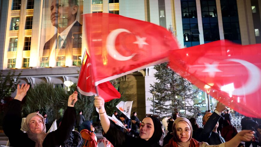 Supporters of Turkish President Recep Tayyip Erdogan and AK Party (AKP) wave flags at the AK Party headquarters in Ankara, Turkey May 14, 2023. 