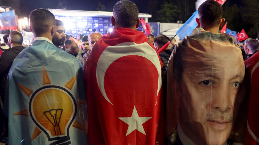 Supporters draped in the flags of the AKP, the Turkish flag and the image of Turkish President Tayyip Erdogan.