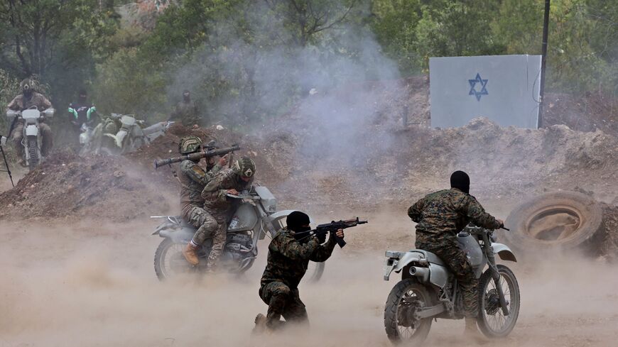 Lebanese Hezbollah fighters take part in cross-border raids, part of large-scale military exercise, in Aaramta bordering Israel on May 21, 2023 ahead of the anniversary of Israel's withdrawal from southern Lebanon in 2000. (Photo by ANWAR AMRO / AFP) (Photo by ANWAR AMRO/AFP via Getty Images)