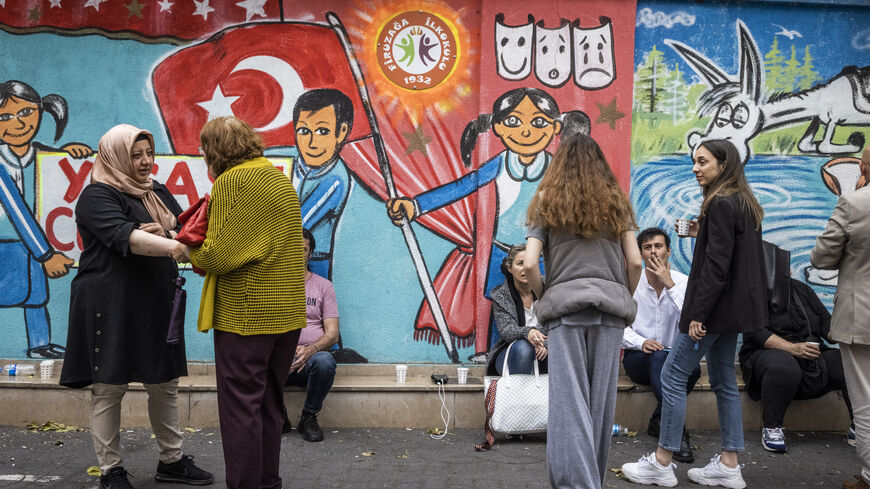  People chat outside a poling station in a school yard on May 28, 2023 in Istanbul, Turkey. President Erdogan was forced into a runoff election when neither he nor his main challenger, Kemal Kilicdaroglu of the Republican People's Party (CHP), received more than 50 percent of the vote on the May 14 election. The runoff vote will be held this Sunday, May 28. (Photo by Ed Ram/Getty Images)