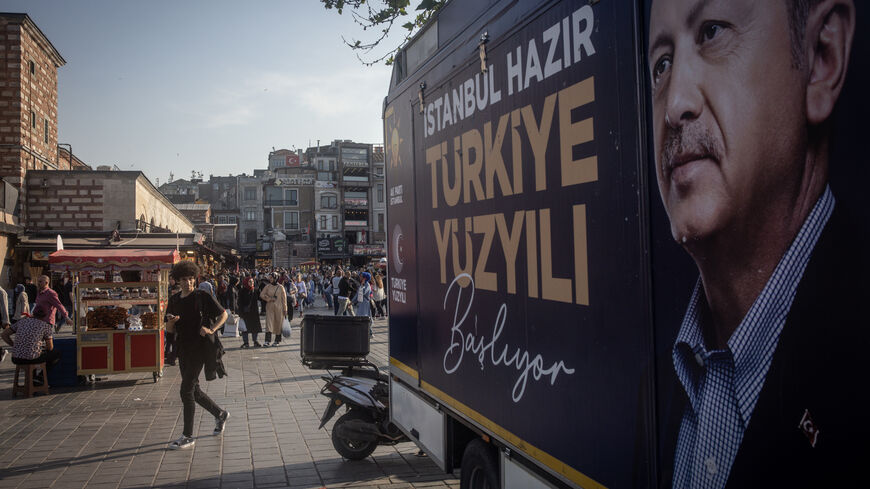 ISTANBUL, TURKEY - MAY 25: People walk past an election campaign poster for Turkey's President Recep Tayyip Erdogan on May 25, 2023 in Istanbul, Turkey. The country is holding its first presidential runoff election after neither candidate earned more than 50% of the vote in the May 14 election. (Photo by Chris McGrath/Getty Images)