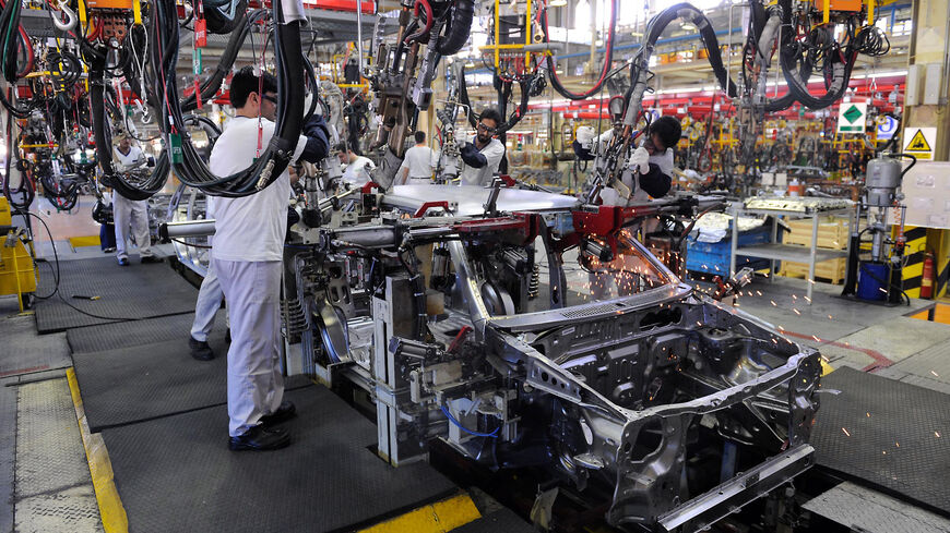 Iranian employees of Saipa auto plant assemble a Tiba (Gazelle) car in the central city of Kashan on May 9, 2010. Iranian President Mahmoud Ahmadinejad inaugurated the largest automobile factory in the Middle East with a capacity of producing 150,000 cars a year, creating 4,000 jobs directly and 20,000 indirectly in the region. The Saipa factory will produce a new small car called Tiba costing between 80 and 90 million Rials (8,000 to 9,000 USD) for lower-middle class population. AFP PHOTO/ISNA/ALIREZA SOTA
