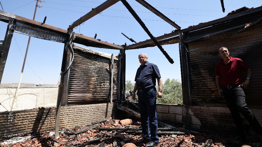 Arab-Israeli Knesset member Ahmed Tibi inspects damage in the Palestinian village of Turmus Ayya after the attack by Jewish settlers 