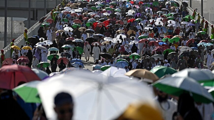 Many pilgrims used umbrellas to shield themselves from the heat