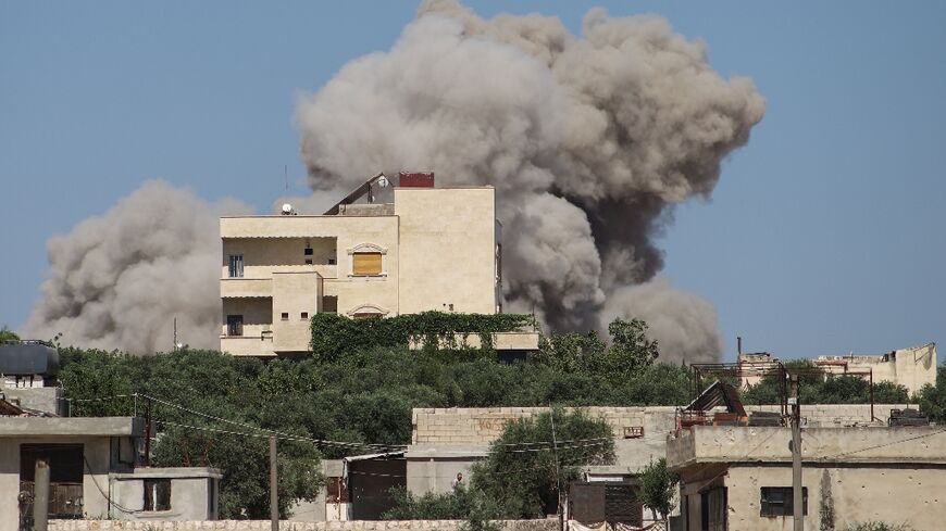 A plume of smoke rises from a building following a reported Russian air strike on Syria's northwestern rebel-held Idlib province, on June 25, 2023