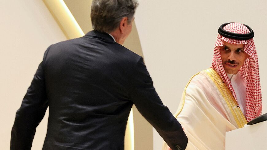US Secretary of State Antony Blinken  approaches to shake the hand of Saudi Foreign Minister Faisal bin Farhan during a joint press conference in Riyadh 