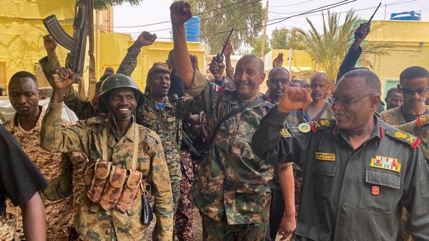 Army chief Abdel Fattah al-Burhan cheering with soldiers in Khartoum in an image released May 30, 2023
