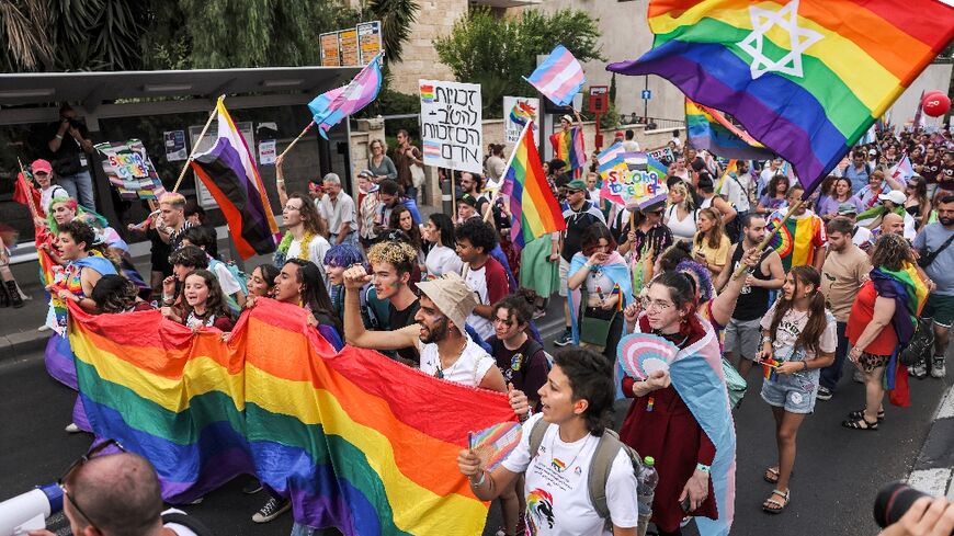 Israelis waving rainbow and transgender flags join the annual Jerusalem Pride parade, among 30,000 to take part this year, according to organisers