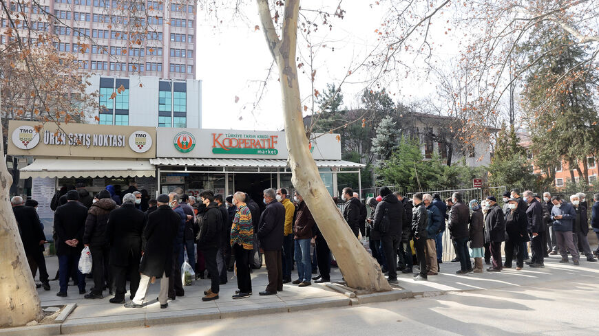 People queue to buy olive oil, which is sold cheaply by the Agricultural Products Office in Ankara, among soaring inflation in the country, Feb. 17, 2022.