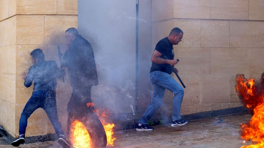 Lebanese protesters clash with bank guards in Beirut during a demonstration called for by the banks depositors committee against monetary policies, on May 9, 2023. Lebanon's economic meltdown, described by the World Bank as one of the worst in recent global history, has plunged most of the population into poverty according to the United Nations. (Photo by ANWAR AMRO / AFP) (Photo by ANWAR AMRO/AFP via Getty Images)