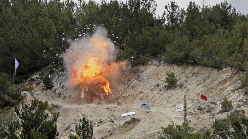 Smoke and fire billow during mock cross-border raids by Lebanon's Hezbollah movement, part of large-scale military exercise, in Aaramta bordering Israel on May 21, 2023 ahead of the anniversary of Israel's withdrawal from southern Lebanon in 2000. (Photo by ANWAR AMRO / AFP) (Photo by ANWAR AMRO/AFP via Getty Images)
