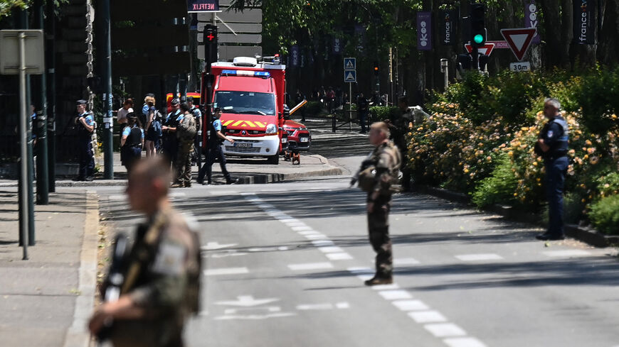 `French police officers stand next to an emergency truck in Annecy following a mass stabbing in the French Alpine town, June 8, 2023.