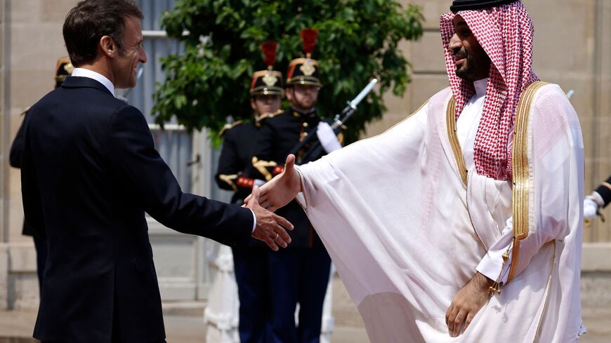 France's President Emmanuel Macron greets Saudi Crown Prince Mohammed bin Salman as he arrives at presidential Elysee Palace in Paris, on June 16, 2023. French President Emmanuel Macron hosts Saudi Arabia's Crown Prince Mohammed bin Salman for talks in Paris, seeking to nudge the de-facto leader of the oil-rich kingdom into more full-throated support of Ukraine against the Russian invasion. (Photo by Ludovic MARIN / AFP) (Photo by LUDOVIC MARIN/AFP via Getty Images)