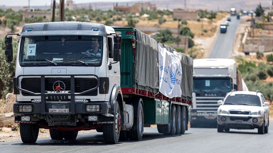 Trucks move in a United Nations aid convoy en route to Syria's rebel-held northwestern city of Idlib on June 23, 2023. 