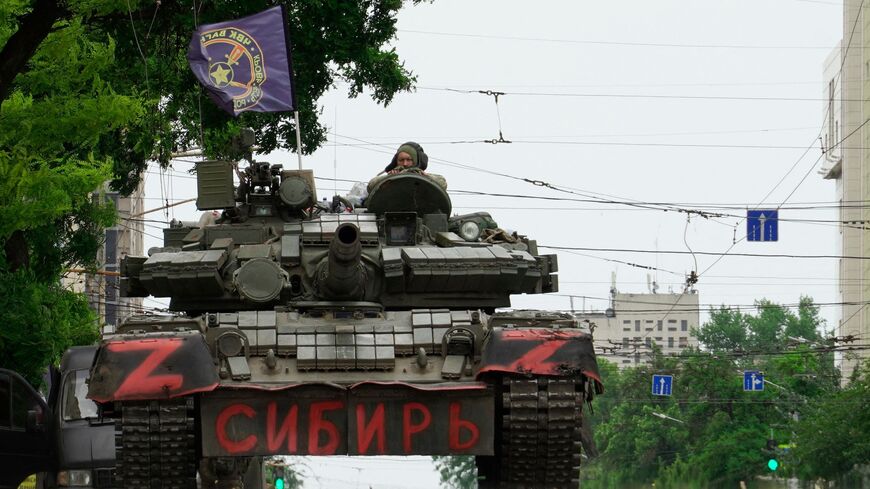 Members of the Wagner group sit atop a tank in a street in the city of Rostov-on-Don, on June 24, 2023.