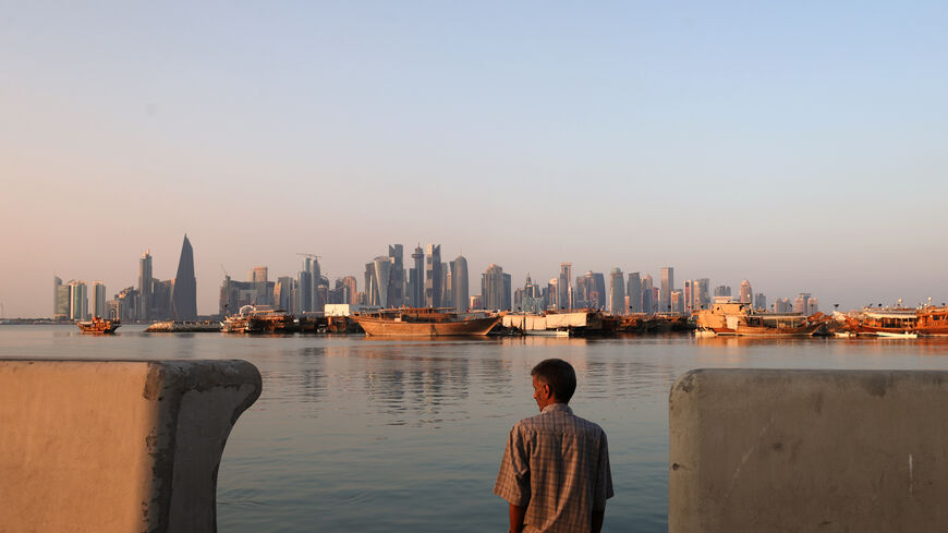 DOHA, QATAR - DECEMBER 15: A man looks out over the Doha skyline on The Corniche during the FIFA World Cup Qatar 2022 on December 15, 2022 in Doha, Qatar. (Photo by Alex Pantling/Getty Images)